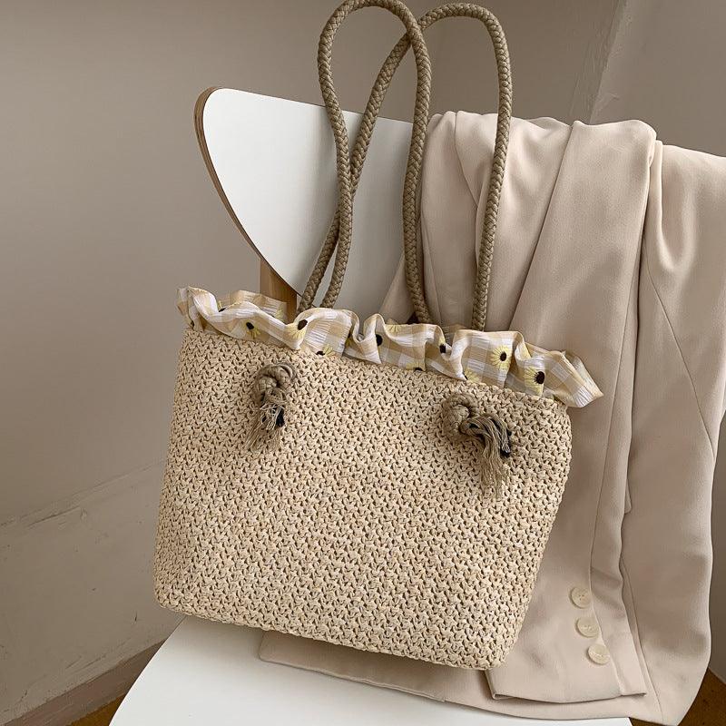 Strohtasche aus geflochtenem Raffia in Weiss und Khaki, ideal für den Sommer, mit Kordelzugöffnung und Doppelseitigen Tragegriffen.