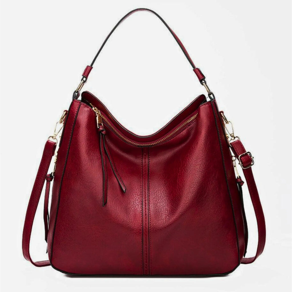 Weinrote Schultertasche aus weichem Rindsleder mit Zipper, Henkeln und langem Riemen