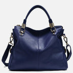 Dunkelblaue Lederhandtasche mit goldenen Details und weichem Crossbody-Riemen