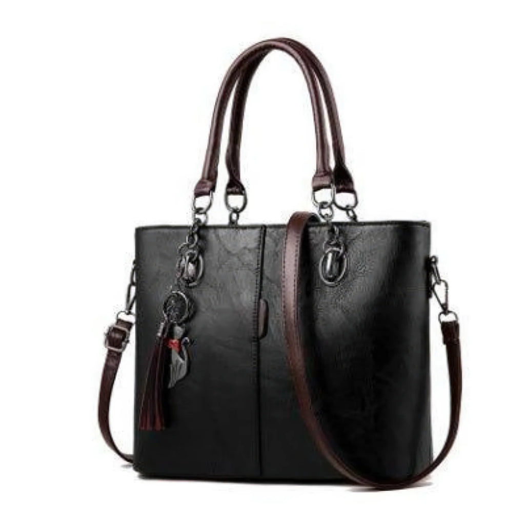 Schwarze Damenhandtasche mit klarer Nahtstruktur, dunklen Griffen und Quaste