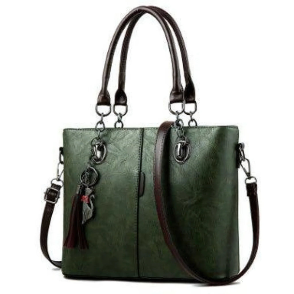 Grüne Schultertasche mit klaren Linien, stabiler Form und braunen Trägerdetails