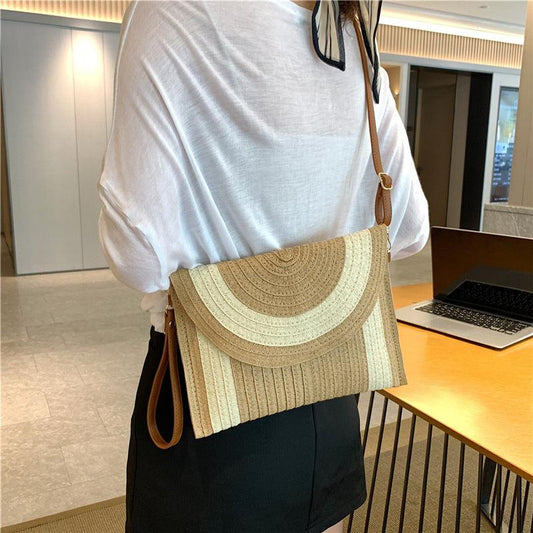 Handgefertigte Strandtasche aus Papiergarn in Cremeweiss, nachhaltig und elegant, ideal für den Sommer.