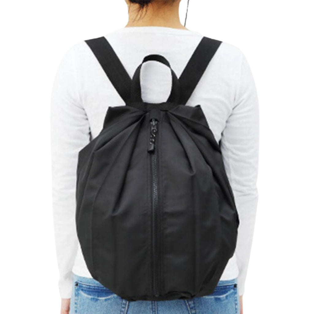 Faltbare Tragetasche in Shadow Black als Rucksack getragen – wandelbar, minimalistisch