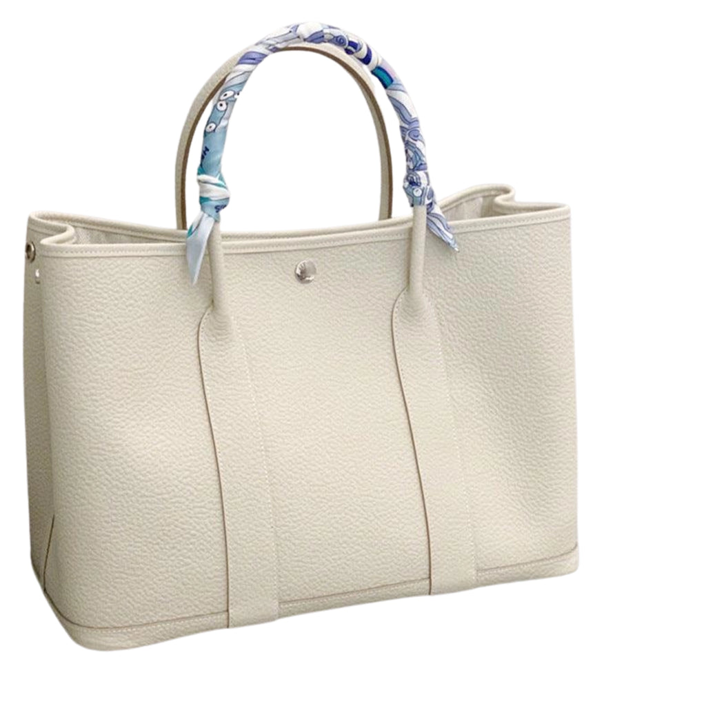 Weisse Kontrasttasche mit strukturierter Oberfläche – schlichter Look mit farbigem Griffband und Magnetverschluss