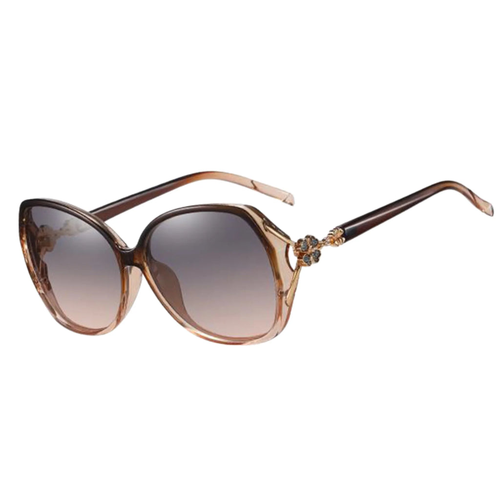 Transparente Sonnenbrille in Braun mit goldfarbenem Dekor und Verlaufsgläsern.