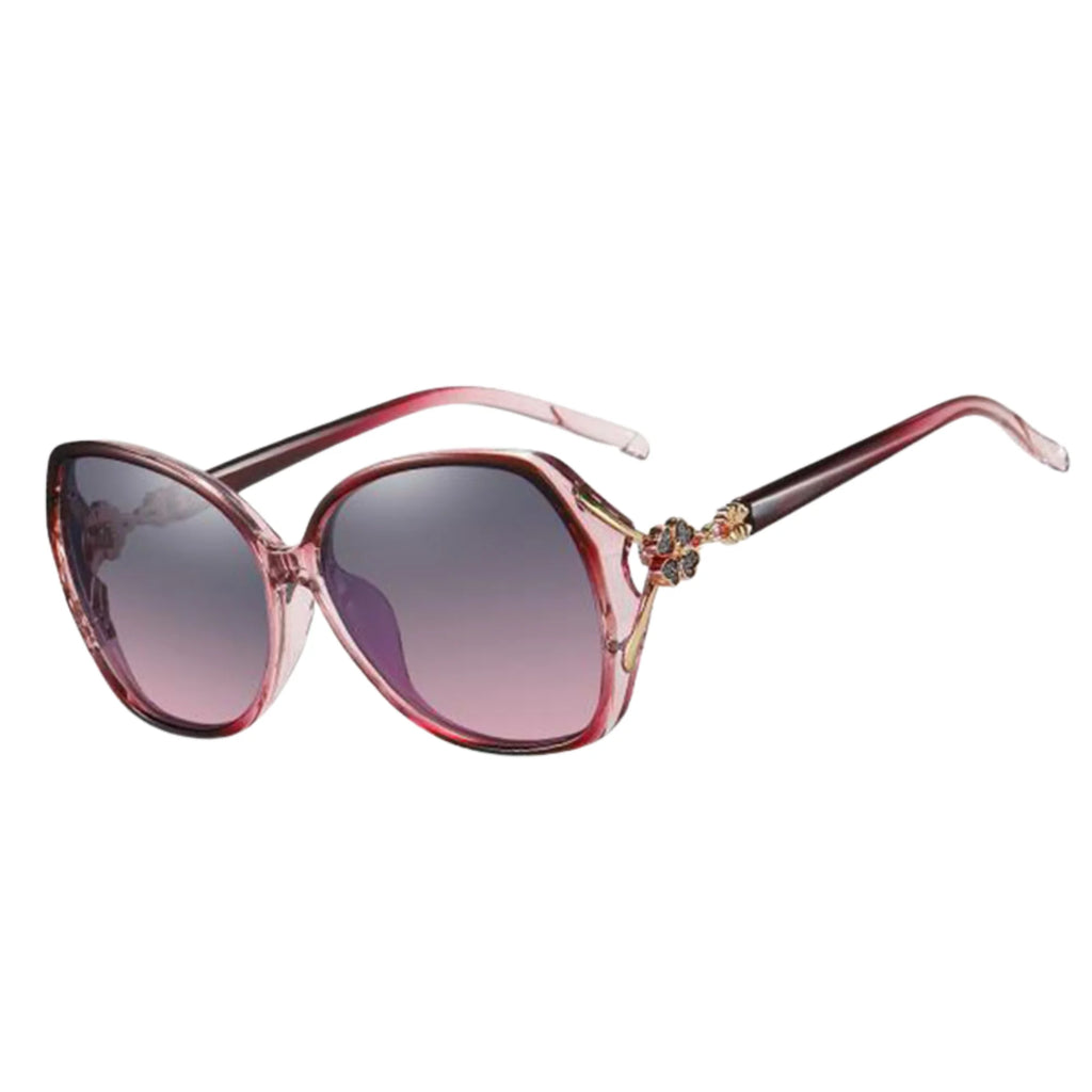 Rosa Oversize-Sonnenbrille mit floralem Detail und weichem Farbverlauf.