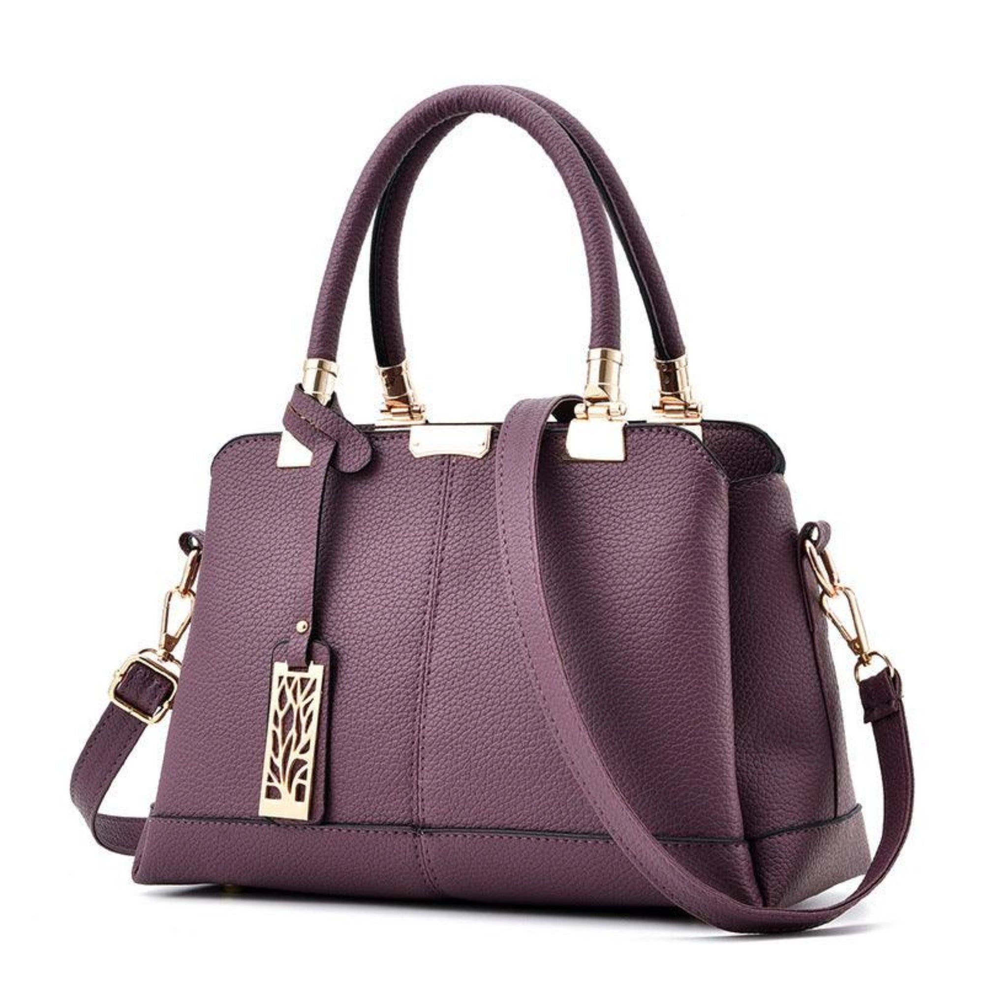 Tief violette Schultertasche mit goldfarbenem Akzent – kompakt, formstabil und stilvoll für den Alltag