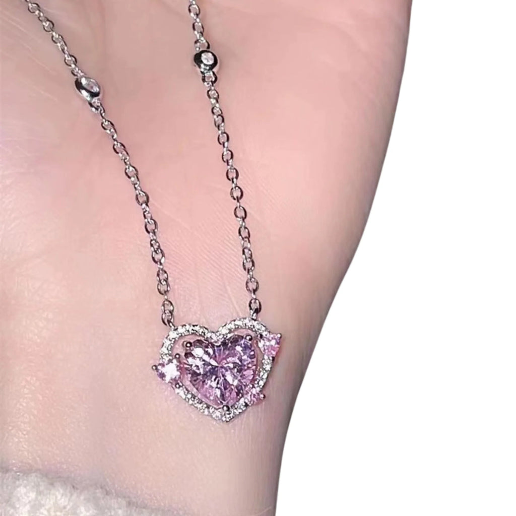 Herzanhänger in Rosa mit zwei Seitensteinen – auf der Hand präsentiert, glänzend und detailreich